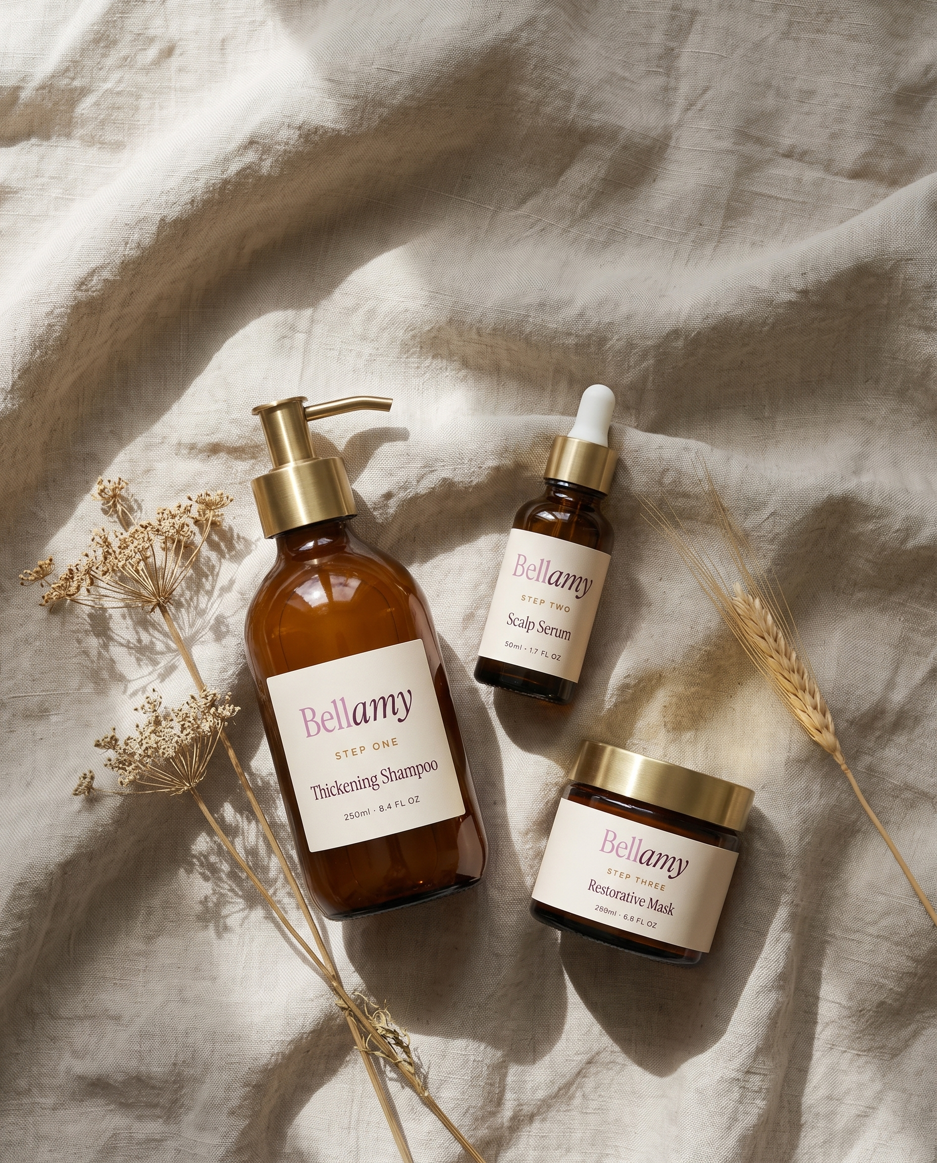 Overhead flat lay of the three Bellamy products on linen